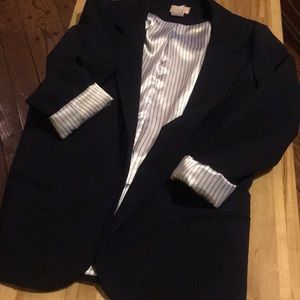 Navy blue blazer with pinstripe detailing.